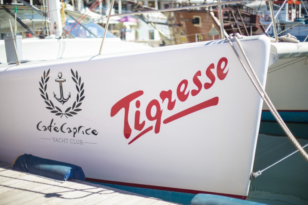 Sailboat with 'Tigresse' name and anchor logo docked.